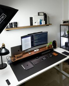 a desk with a monitor, keyboard and mouse on it