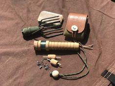 an assortment of items laid out on top of a brown cloth covered table with earbuds