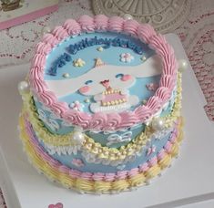 a three layer cake decorated with pastel colors