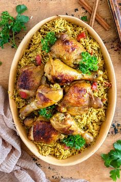 chicken and rice dish with parsley garnish in a bowl on a wooden table