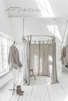 a white room with some clothes hanging up