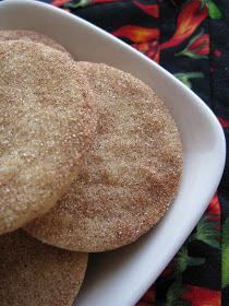 three cookies are in a white bowl on a table