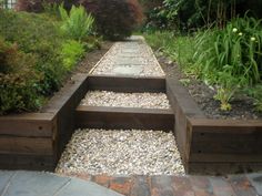 an outdoor garden with steps leading up to the house