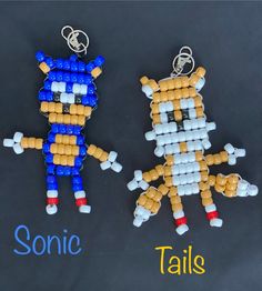 two key chains made to look like sonic and tails