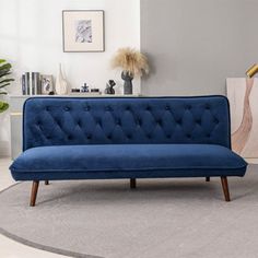 a blue couch sitting on top of a rug in a living room