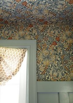 the ceiling is covered in an intricately designed wallpaper