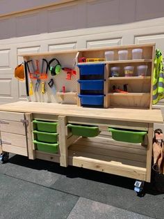 a wooden workbench with lots of tools on it's sides and drawers