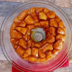 a bundt cake sitting on top of a glass plate covered in caramel sauce