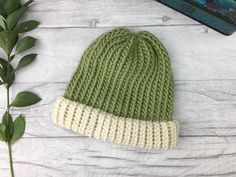 Sage green and cream hand knitted hat made from 100% pure wool (merino and shetland).  Our hats are pure wool so are naturally breathable and help control your temperature so you don't get too hot or too cold.  We sell a wide range of different colour hats. Please find our full range here: https://www.etsy.com//shop/TheDorothyDays?ref=listing-shop-header-item-count&section_id=20861918 We believe in beautiful, practical and long lasting items which are unique, a joy to own and will be treasured for many years to come.  || Features || - Sage green and Natural Shetland (cream)  - Designed to fit snug to your head - 100% wool  - Available with or without a pom pom  - Pom pom (if requested) will be in 'Natural Shetland', an undyed cream yarn as standard. If you require a matching pom instead pl Sage Green And Cream, Chunky Knit Beanie, Knit Structure, Hand Knit Hat, Chunky Wool, Baby Head, Green Wool, Knitting Accessories, Knitted Hat