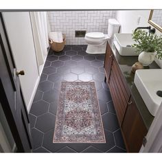 a bathroom that has a rug on the floor