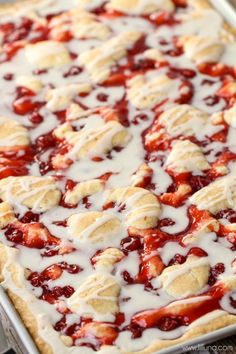 a close up of a dessert with strawberries and cream on it's toppings