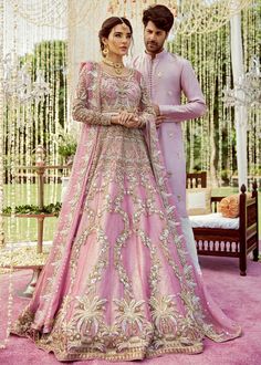 a man and woman standing next to each other in front of a wedding ceremony arch