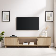 a flat screen tv mounted to the side of a wooden entertainment center in a living room