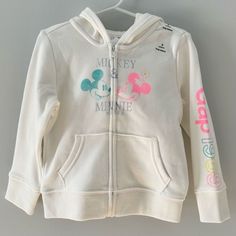 Nwt Gap Kids And Disney’s Mickey Mouse & Minnie Mouse White Zip Up Hooded Sweatshirt ** New With Tags ** New And Never Used. All Stickers And Tags Still On. Beautiful Bright White With Neon Pink And Blue. I Love The Gap Logo 1969 On The Left Arm Especially. 77% Cotton 14% Polyester 9% Recycled Polyester Size: 3t (90cm) Gently Preowned And Always Happy To Put A Bundle Together With Other Items At A Discount. Smoke Free - Pet Free Home Cute White Outerwear With Drawstring Hood, Pink Cotton Hoodie By Gap, White Cotton Sweatshirt For Playtime, Cotton Hoodie With Adjustable Hood For Playtime, Playful White Sweatshirt For Fall, White Sweatshirt For Playwear In Fall, White Fall Sweatshirt For Playwear, White Fall Sweatshirt For Play, White Sweatshirt For Fall Play