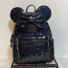 Loungefly Disney Minnie Mouse With Bow Black Holographic Celestial Sequin Mini Backpack Exterior Top Zip Main Compartment Small Front Zip Pocket 2 Small Open Side Pockets Interior Single Main Compartment No Pocket Nwt Will Be Shipped In A Box With Care Totoro Umbrella, My Little Pony Backpack, Cinderella Mice, Black Holographic, Disney 50th Anniversary, Disney Loungefly, Disney Brave, Grey Backpacks, Loungefly Bag