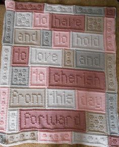 a crocheted blanket is laying on the floor with it's name written