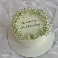 a birthday cake with the words happy birthday written in frosting and flowers on top