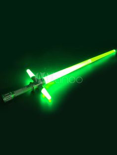 a green light saber with two lights on it's side and one glowing in the dark