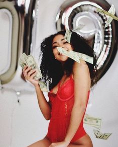 a woman in a red bathing suit holding money