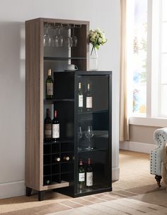 a black cabinet with wine glasses and bottles in it next to a chair on the floor