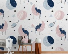 a baby's room with a wallpaper that has stars and llamas on it