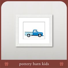 a blue truck is framed in a white frame with the words pottery barn kids below it