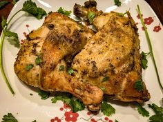 a cooked chicken sitting on top of a glass plate