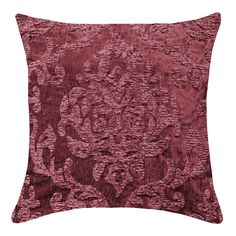 a red velvet pillow with an intricate design on the front and back, in shades of pink