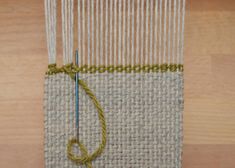 a close up of a piece of cloth with yarn on it and a knitting needle