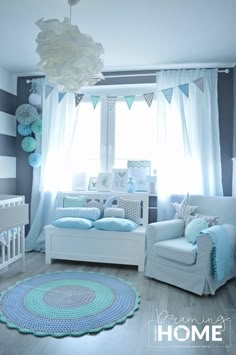 a baby's room is decorated in blue and gray colors with crocheted rugs on the floor