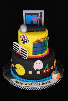 a birthday cake with an image of a tv and sunglasses on it's top