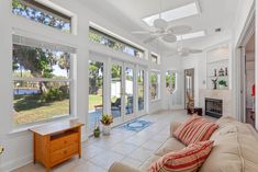 a living room filled with furniture and lots of windows