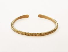 One Gold cuff  bracelet ,that stands out with it's special design.. one of a series of special  Bangles ( see them in my shop) that can be worn alone or a few together-as stackable cuffs.  A Unisex brass bangle bracelet, Boho cuff bracelet, This  beautiful  delicate piece of ethnic jewelry, Will give a special golden look to anything you were.  A special hand made present from Jerusalem   FEATURES: One cuff  bracelet Made of Brass Hammered and ornamented by hand, in an Ethnic style Shape: oval  Weight : 18.5 gr. Diameter : see in photos  Packaged carefully in a charming gift box. With a special small  polishing cloth for silver and brass jewelry. Delivery: Takes 7-28 Business days depending on your location. To see other BRACELETS with another design:     www.etsy.com/il-en/listing/1543138 Artisan Gold Cuff Bangle Bracelet, Artisan Gold Bangle Cuff Bracelet, Unique Brass Bangle For Wedding, Artisan Gold Brass Bangle, Handmade Brass Cuff Bangle, Handmade Adjustable Bangle For Ceremonial Occasions, Artisan Gold Brass Bracelets, Handmade Brass Bangle Cuff Bracelet, Handmade Brass Cuff Bracelet Bangle