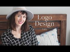 a woman wearing a hat sitting on top of a bed next to a wooden headboard