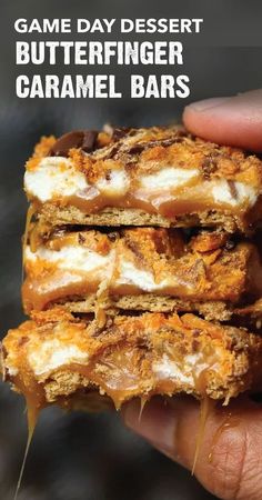 a hand holding up some food with the words game day dessert butterfingerer caramel bars