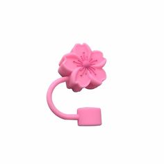 a pink plastic object with a flower on it's end and a hook in the middle