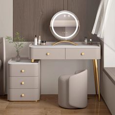 a white dressing table with a mirror and stools in front of it on a wooden floor