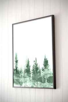 a painting hanging on the wall with trees painted on it