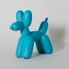 a blue toy dog sitting on top of a white table