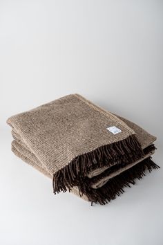 a brown and black blanket on a white background