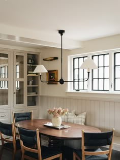 a dining room table with four chairs around it