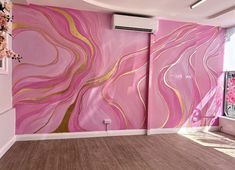 an empty room with pink and gold paint on the walls