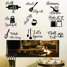 kitchen wall decals with words and cooking utensils on the wall in front of a stove