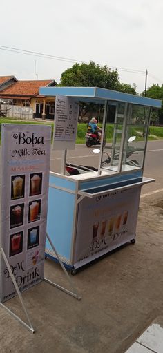 a food cart sitting on the side of a road