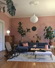 a living room filled with furniture and potted plants