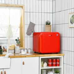 a red refrigerator sitting on top of a kitchen counter