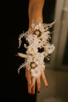 a woman holding a bouquet of flowers in her hand