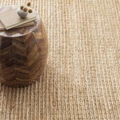 a wooden box sitting on top of a carpeted floor next to a note pad