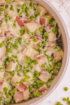 peas and ham are mixed together in a casserole dish