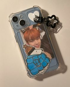 a cell phone case with an image of btops on the back and a keychain attached to it